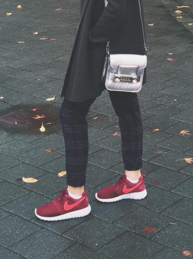 Gabi Passos in her Roshe Runs. Paired with plaid pants a silver cross body bag and gray coat.