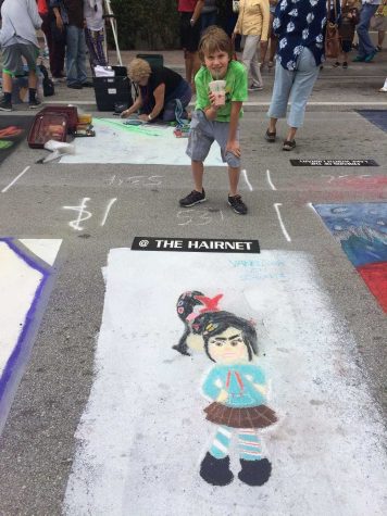 Wesley Wendel stands with his piece "The Hairnet" at the Lake Worth Street Painting Festival. 