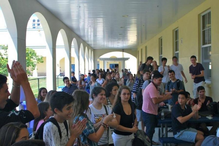 Summer is over and students are back to bustling about the campus. Outside of the cafeteria during lunch, a pigeon flew under the overhang, causing a stir among the students.