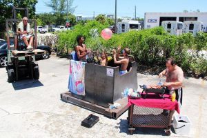 "Have a pool party with at least three guests swimming. In this case, your 'pool' shall be made from a large garbage can or dumpster. The party must also include towels, a BBQ, cocktails and flotation devices. All three must be in the 'pool'. Bonus points if it's a dumpster." 