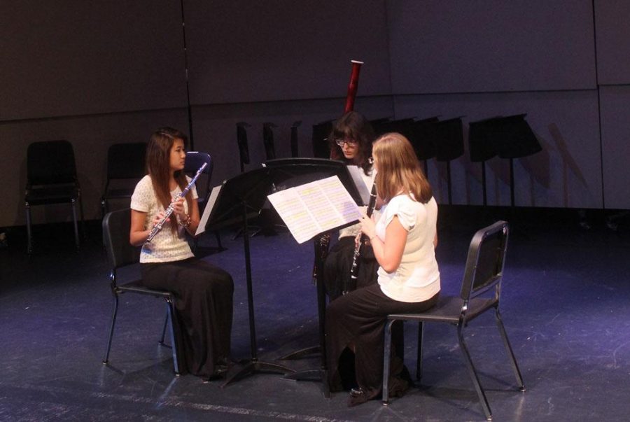 From Left, band sophomore Amber Chu, band senior Valerie Martin and band sophomore Fiona Riso getting ready to play “Haydn Suite.”