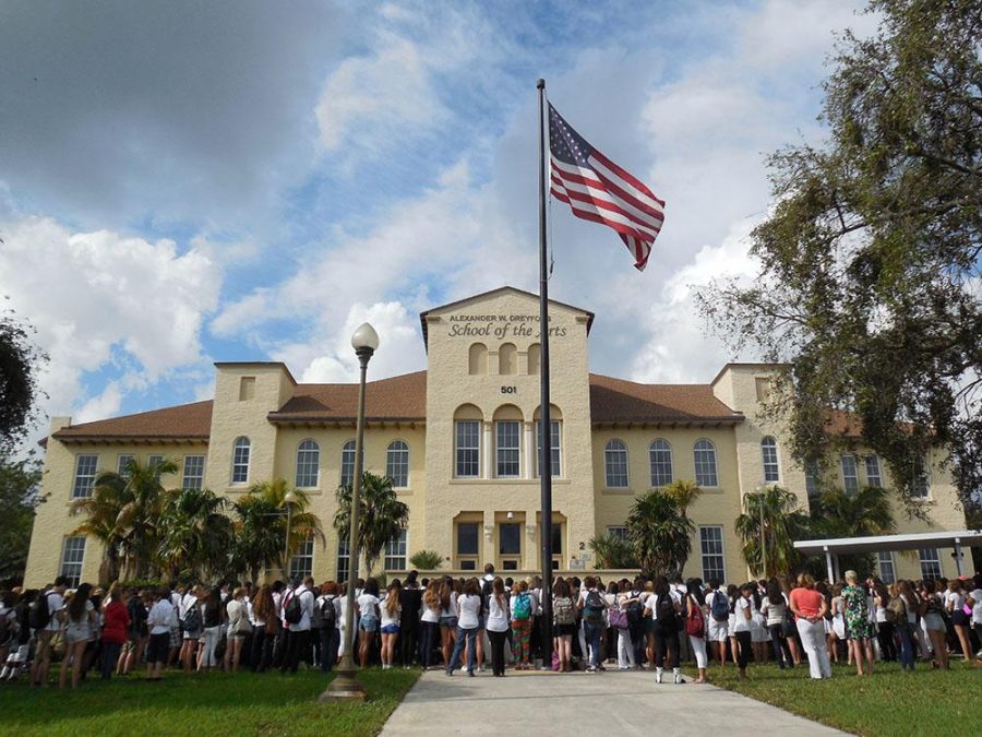 Students gather by the flag pole near the from of the school for a memorial vigil sponsored by the Jewish Student Connection and First Priority for Alex and Jackie Berman. 