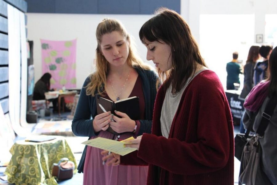Digital media senior Meredith Padgett (left) speaks to a college representative (right) about her artwork. Visual and digital media juniors and seniors has all-day SRAs today to participate in portfolio day in the Gym.