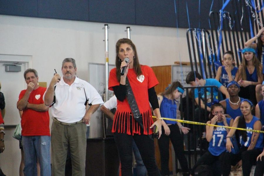 Principal Dr. Susan Atherley announcing the time restraints of the Pep Rally Finale. 