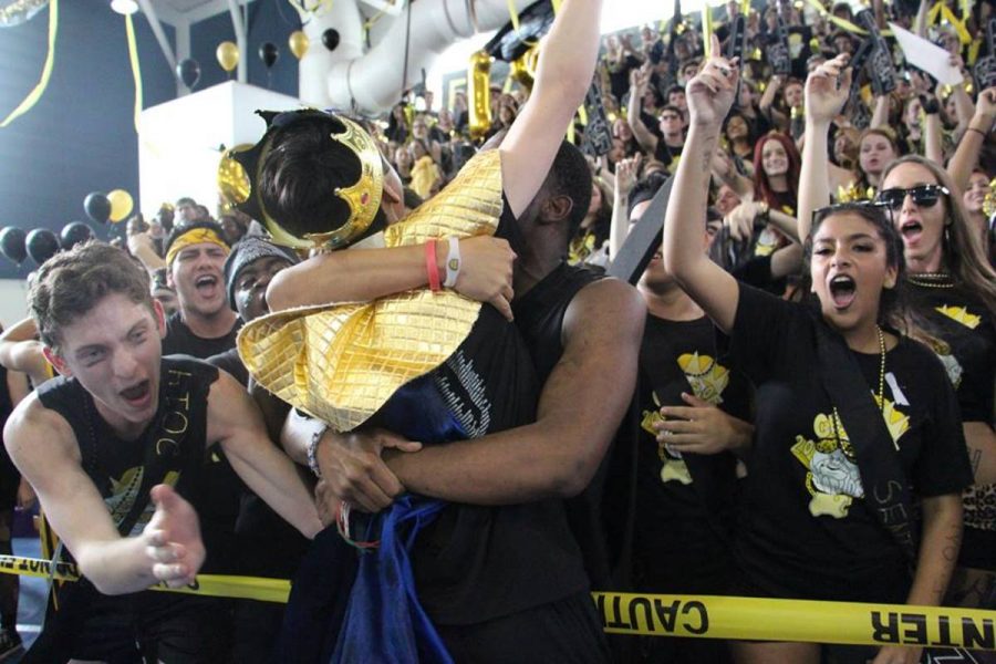 Digital media senior and senior class council president Daniel Martin is embraced by his class after winning in Musical Chairs. 