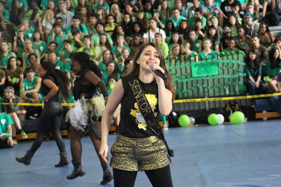 Communications senior Tess Sapperstein rapping as part of the senior class singers. 