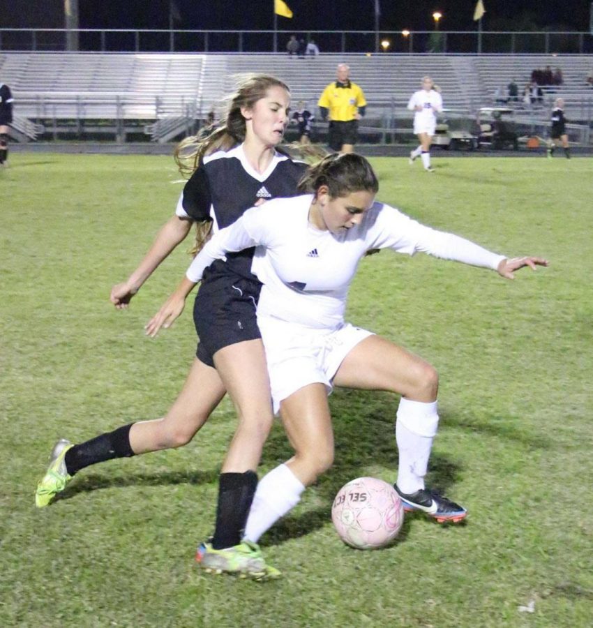 Communications senior and girls soccer player (left) Sarah Maclean battles for the ball in her teams second district match that took place at Olympics Heights High School against William T. Dwyer High School.
