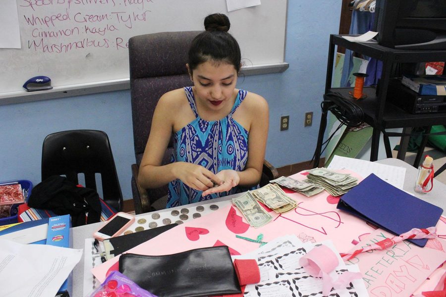 Communications senior Angelic Edery counts the money from todays carnation sales during lunch. Today was the last day to purchase carnations to be delivered to your valentine tomorrow during your 4th or 6th period. Seeds made nearly $300 i todays sales alone.