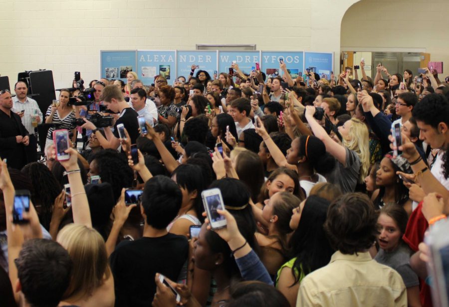Students crowd around the turntable to get a picture of Nick Cannon as he arrived in the cafeteria. 