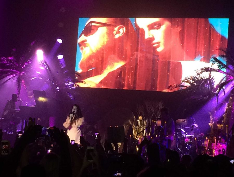 Lana Del Rey performing "Ride," from her 2012 EP Paradise as the screen projects scenes from it's music video.