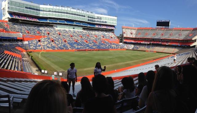 College tour guide Christina Bienaime talks to the visiting students about the University of Floridas stadium.