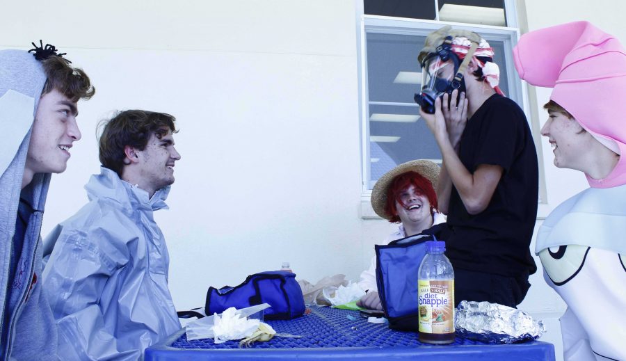 Theater Junior Matthew Dickenson tries Communication junior Brett Marr’s gas mask on, which goes with his hazmat Halloween costume. The group dressed up as a variety of characters, from Eyore to Shanks from the anime, One Piece.