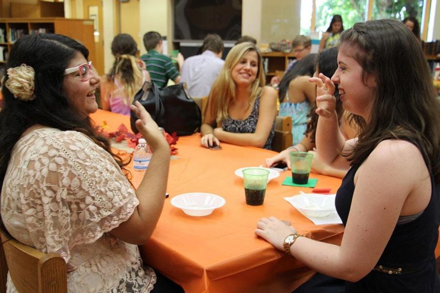 Communications seniors Aleya Z. (l-r) and Mackenzie White talk before the Communications Honor Society induction. 