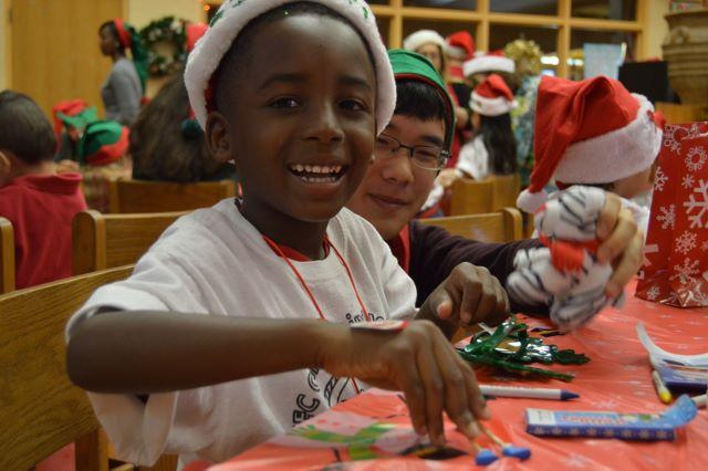 (L-R) Canal Point Elementary student and band junior Minh Ton express their jolly spirits while playing with gingerbread man toys.