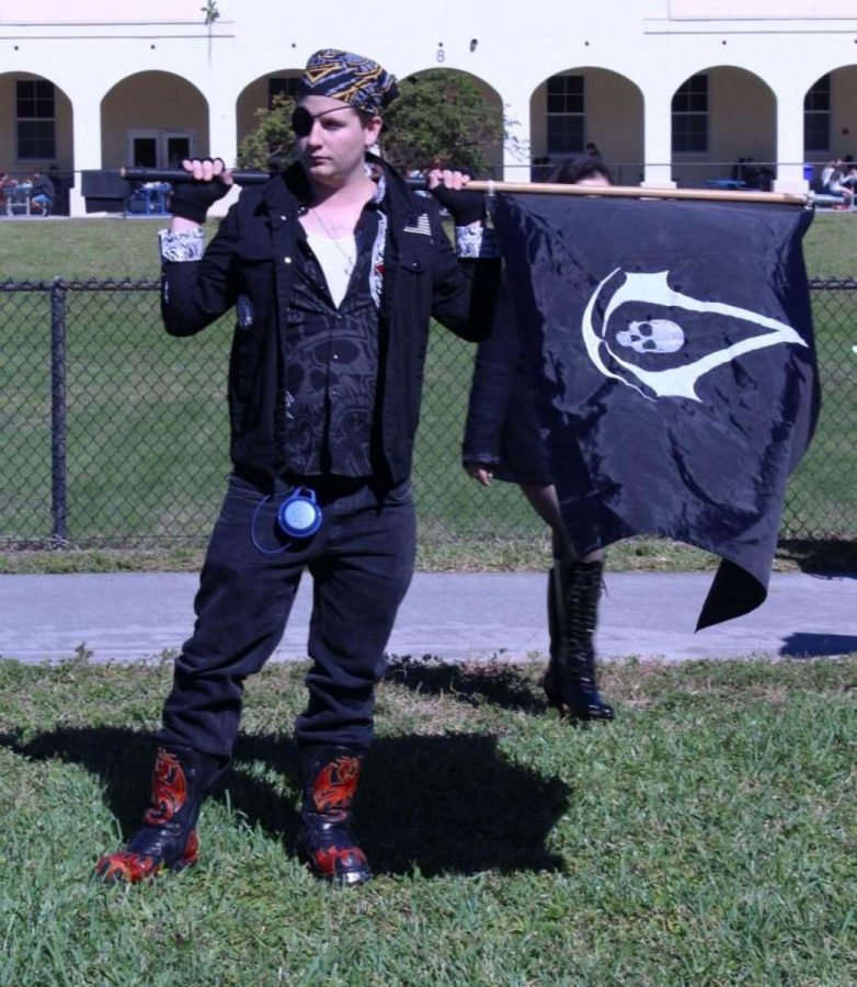 Theatre senior Kenan Brown hold a black rebel flag on the field today during the Spirit Week activities. 