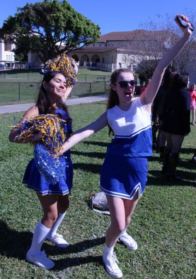 Communications junior Carla Flores and theatre junior Rachael Labes cheer on their class in the 50 yard dash. 