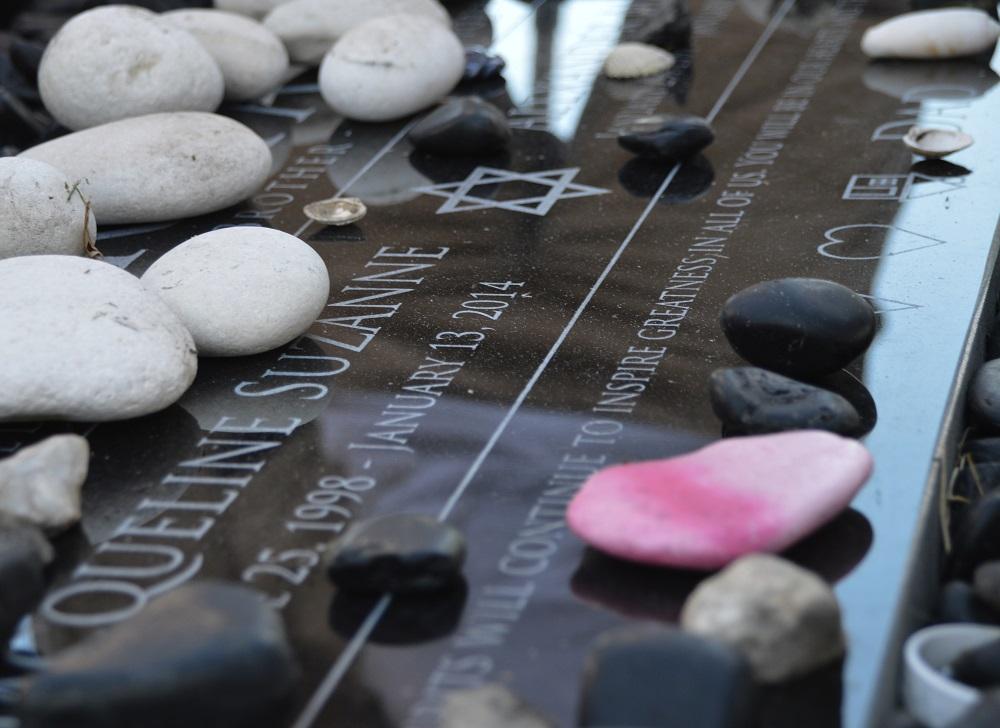 The headstone of strings senior Alex Berman and strings junior Jackie Berman with tokens of loved ones who have visited them.