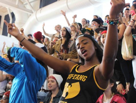 Dance senior Kristen Lee cheers for her classmates in a game of dodge ball while dancing to “Anaconda” by Nicki Minaj. Today’s activity was originally kickball on the soccer field, but plans were changed due to the weather. 