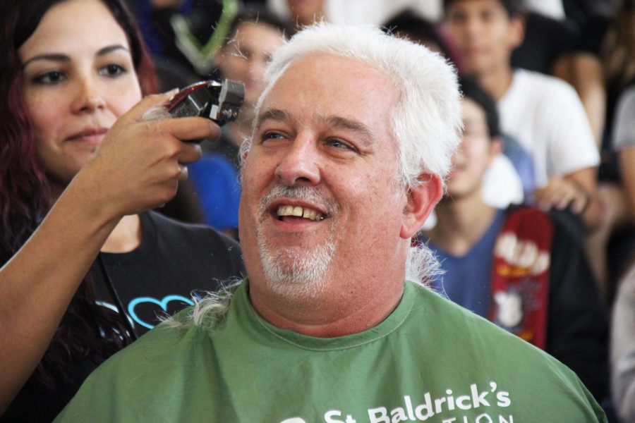 Math teacher Christopher Coombs shaves his head to raise awareness for childrens cancer.