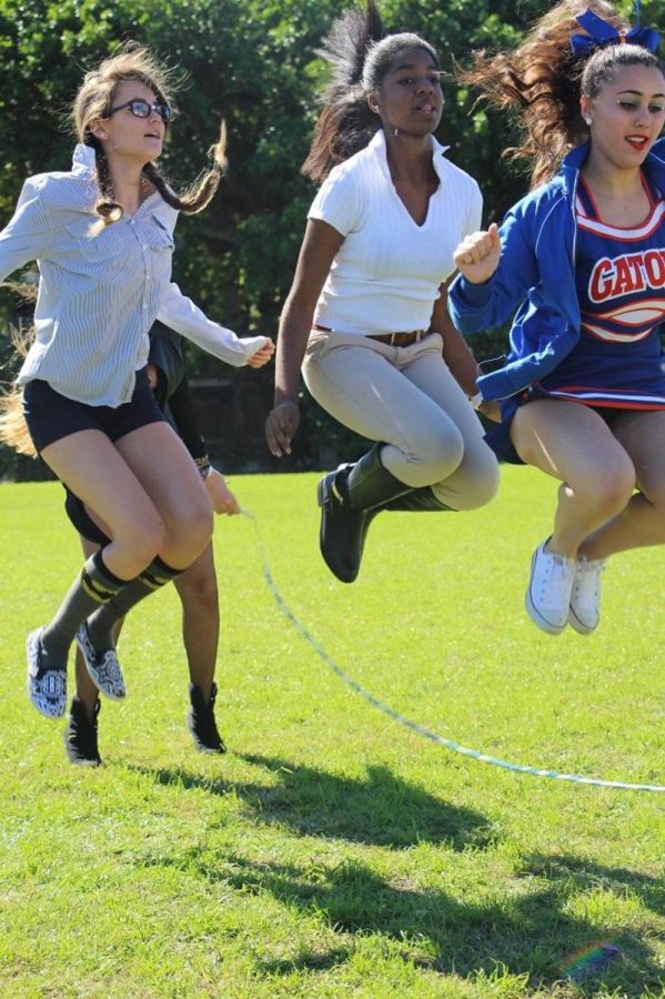 Communications freshman Chantel Mcmillan (l-r), sophomore, and dance junior Olivia Izenwasser jumping in the Quadruple Dutch event today during lunch. 