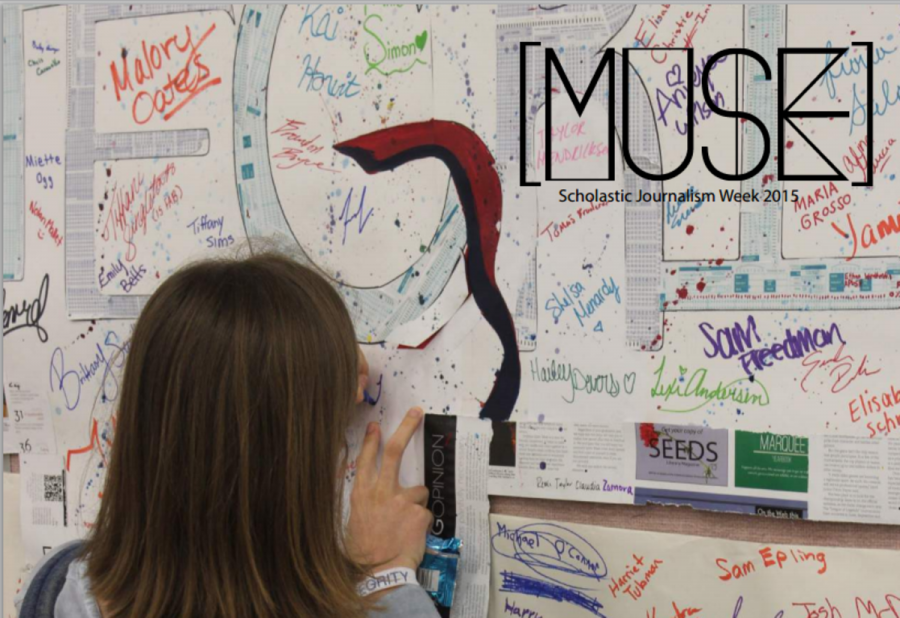 Piano senior Lauren Hammett signs the integrity banner during lunch at the White Out party. 