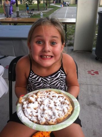 7-year-old Jaida Ralph exhibits her excitement for a deep fried funnel cake at the Jerry Thomas Elementary School Fun Fair. 