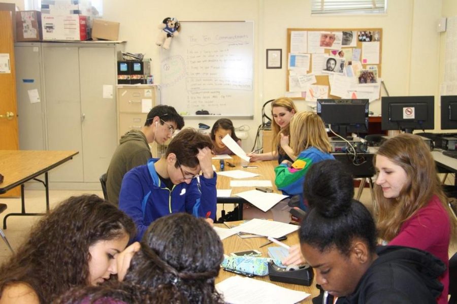 National English Honor Society members help members of Seeds Literary and Arts magazine put the finishing touches on edits of this year's book. String senior Fabiola Plaza (L-R), visual junior Zachary Rapaport, communications sophomore Peter Rawlik, communications junior Michelle Birch, theatre junior Drew Lederman, digital junior Madelyn Winchester, communications senior Remi Lederman and piano senior Morgan Oliver edit poems and prose that will be in the book. 
