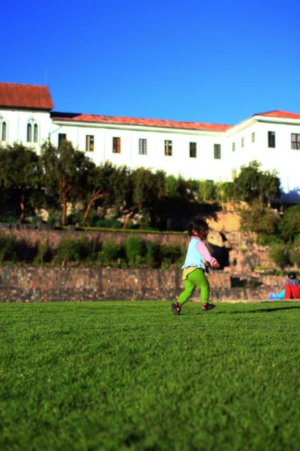 A Peruvian girl runs to catch a ball outside the Qorikancha Museum in Cuzco. This museum was a temple in Inca times whose walls were once covered with solid gold. 
