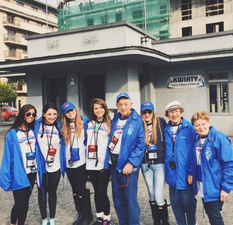 Theatre senior Amamnda Shore (third from left) and visual senior Emily Gerstein (third from right) gather among other particpants of The March of the Living and a holocaust survivor (middle). 