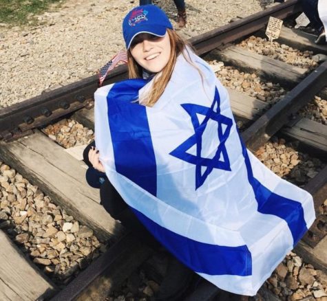 Visual senior Emily Gerstein sits on train tracks during t The March of the Living.
