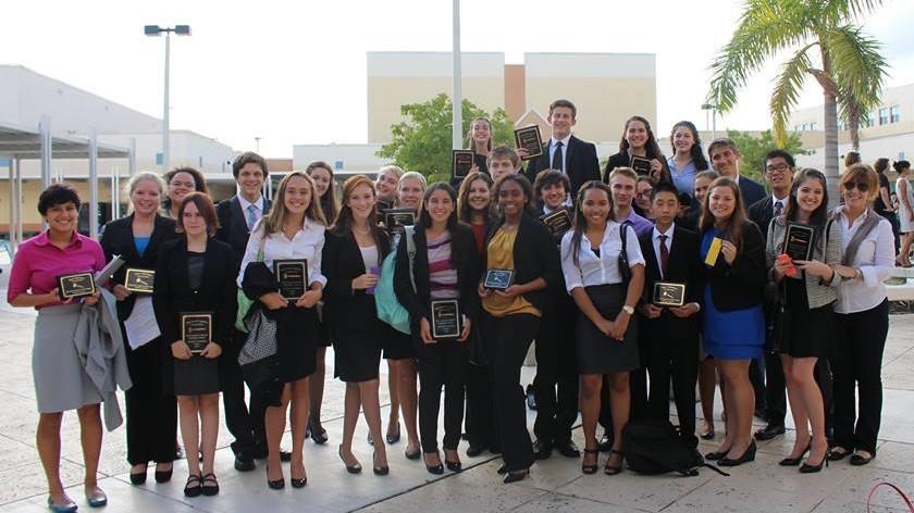 Members of the debate team pose with their awards. 