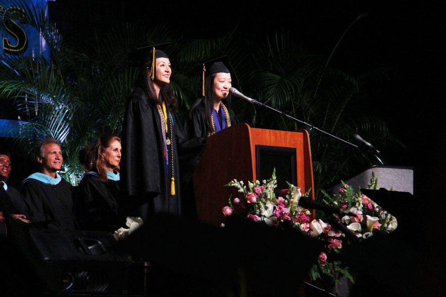 Salutatorian+communications+senior+Ximena+Hasbach+and+valedictorian+piano+senior+Jackie+Chen+give+a+joint+speech+to+the+Class+of+2015.