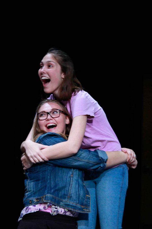 (L-R) Theatre sophomore Kelly Fleming and theatre sophomore Emma Ridley embrace at the sight of the abominable snowman at Hairy Details last show during lunch.