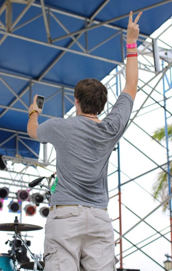 Palm Beach Gardens High School junior John Cardillo III takes a selfie with the crowd during Jumbo Shrimp’s performance at SunFest on Sat. May 2.