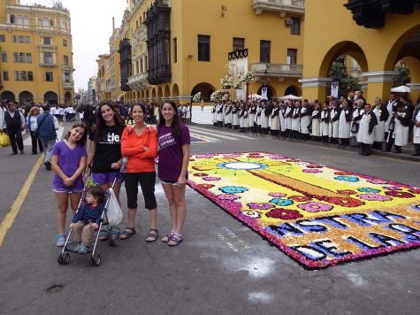 Kapitulnik and her family at the Plaza de Armas in Lima, Peru. At the time, the Corpus Christi festival was going on, where pieces of art, like the one shown, displayed religious symbols made solely from flower petals.