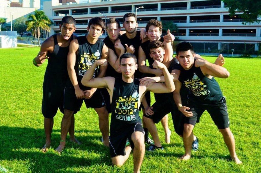 Band+alumnus+Eric+Miessau+%28second+from+left%29+poses+with+his+friends+during+their+senior+pep+rally+in+2012.+