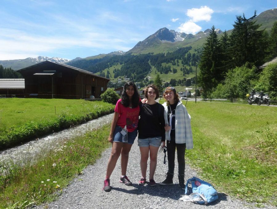 (L-R) Communications juniors Uma Raja, Samantha Marshall and Brianna Steidle take a picture in front of the Swiss Alps in Davos.