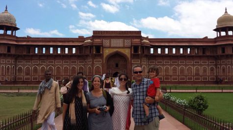 Communications junior Tom Kapitulnik (middle) stands with her family in front of the  red fort in Agra, India.