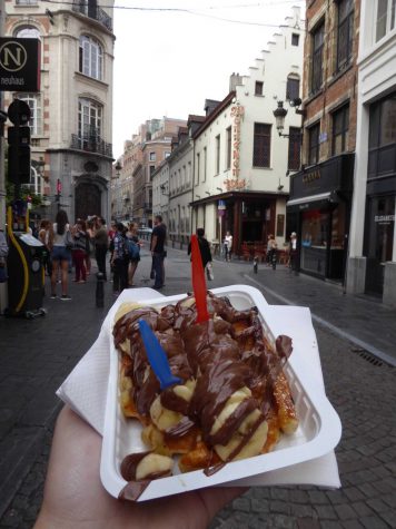 Communications junior Tom Kapitulnik holds a Belgian waffle in Brussels, Belgium.