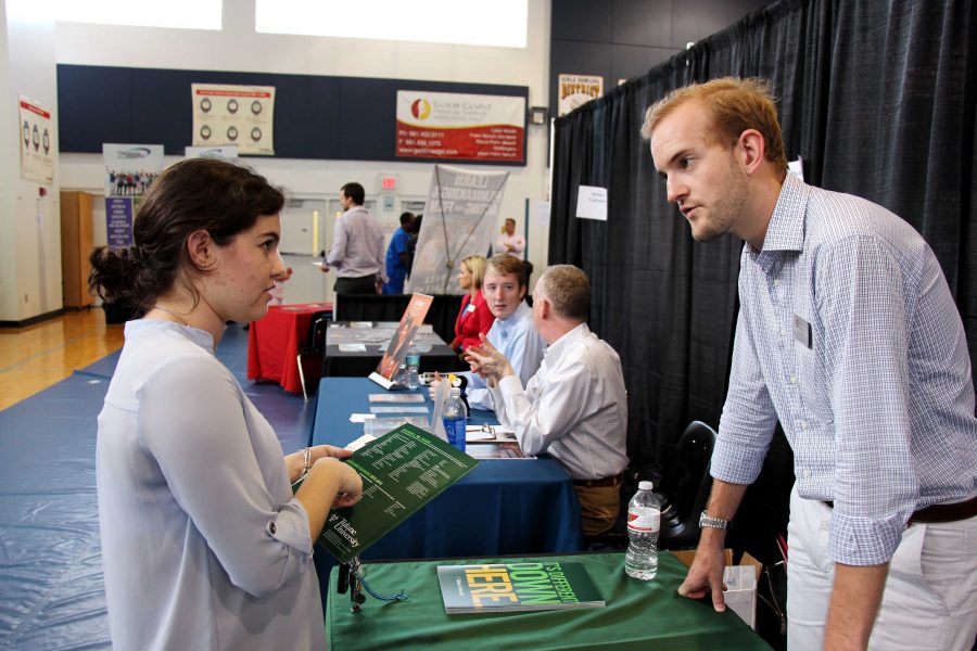 Theatre senior Alyssa Gates talks to a representative of Tulane University at Dreyfoos’ College Fair on Oct. 7. The fair 
was held in the gym from 4 p.m. to 6:30 p.m. and over 70 colleges were represented.