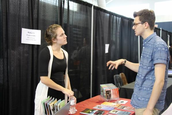 Communications junior Matt Nadel speaks with a representative of Rutgers University about film at Dreyfoos College Fair. 
Im looking at very specific majors and programs for college, and its helpful to compare the programs offered by each school literally side-by-side, Nadel said. The representatives from each college also provide the kind of insight into school culture that the website just cant provide. 
Over 70 colleges were represented in the gym from 4-6:30 p.m. on Oct. 7. 