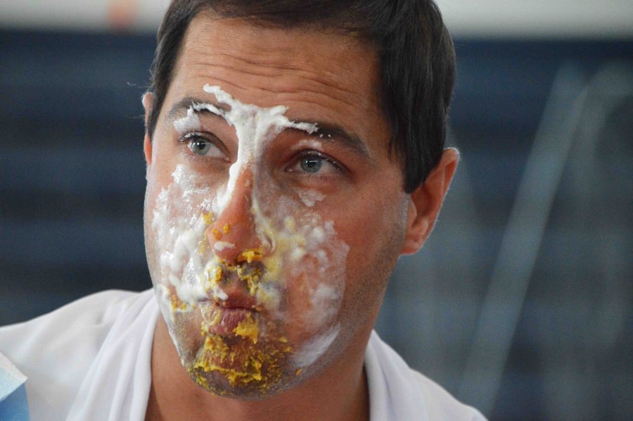 Science dean Stephen Anand competes for the junior class in the pie eating contest  during the Fall Festival.  Juniors got second place, while seniors got first place with science teacher Michael Rathe.