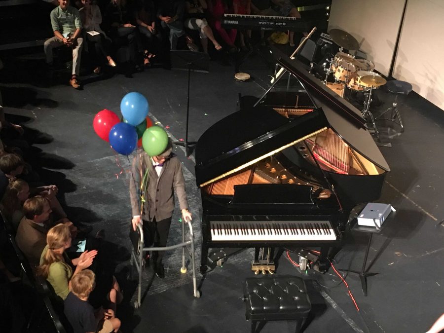 Piano junior Stefan Wan dresses as Carl Fredricksen while playing the main theme from Up during the Oct. 9 performance of Impromptu. We have the walker with the balloons, and Stefan Wan actually arranged it himself, piano junior Natalie Shteiman, who performed the piece with Wan, said. 