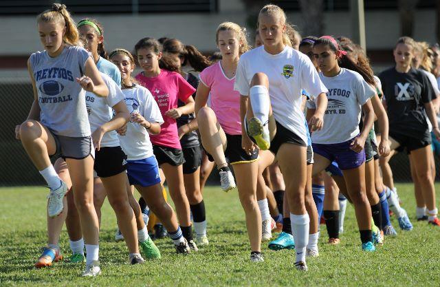(L-R) Digital media senior Maddy Winchester and band senior Kaitlyn Svopa run with the rest of the girls soccer team during preseason conditioning.