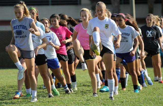 %28L-R%29+Digital+media+senior+Maddy+Winchester+and+band+senior+Kaitlyn+Svopa+run+with+the+rest+of+the+girls+soccer+team+during+preseason+conditioning.