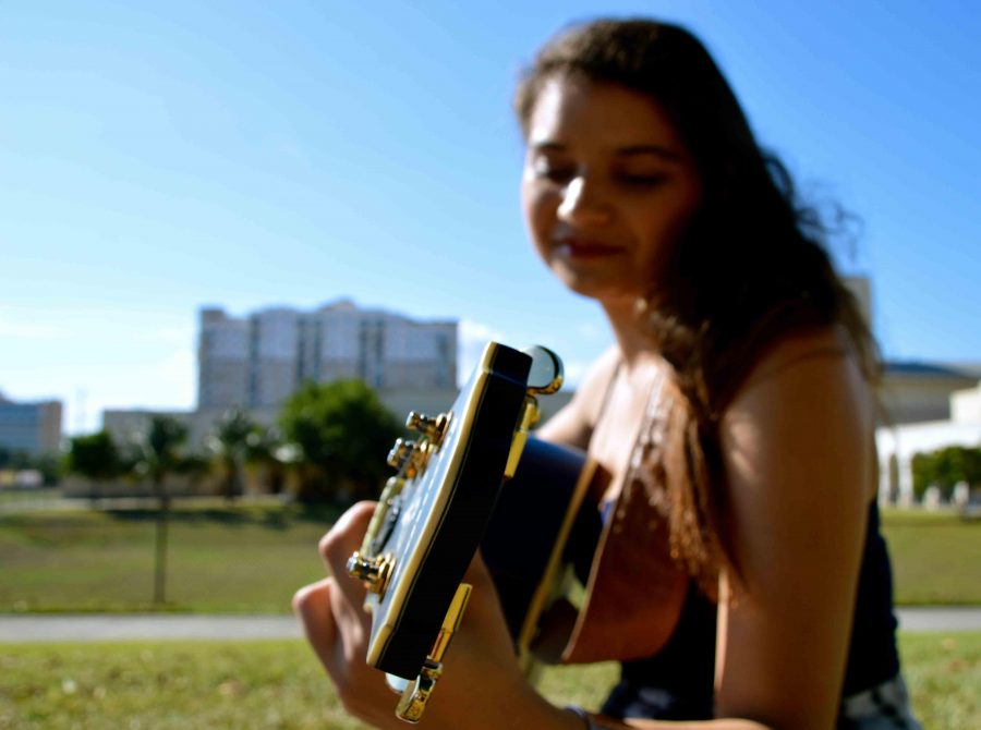 Strings sophomore Nicole Lickstein practices her guitar on Freshman Hill. Lickstein has been practicing for years and recently released a single titled Ex Crush off her upcoming album. 