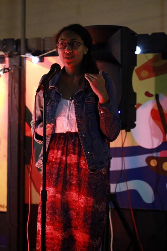 Communications senior Tiffany Abreu performs her poem Three at Seeds Open Mic Night at Harolds Coffee Lounge on Tuesday, Nov. 17. 