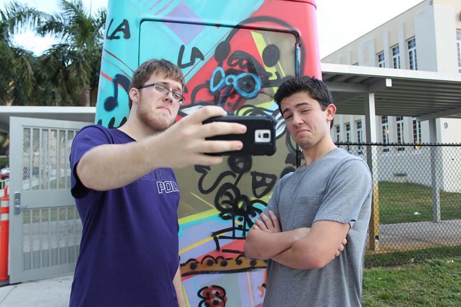 Taking a selfie with the coke cart, theatre senior Marshall Tobias (L-R) and band senior Daniel Stern compete in the National Honor Societys (NHS) first social event. The event featured a scavenger hunt requiring participants to solve clues that led them to a specific location where they took a selfie.