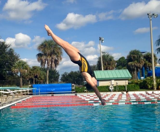 Communications freshman Finnley Senese performs a dive at the Calypso Bay  water park in a Dreyfoos swim and dive match against Seminole Ridge on Sept. 30. A back injury in 2012 suspended Seneses ability to dive for some time, but she is now working on getting back to her previous performance level. 