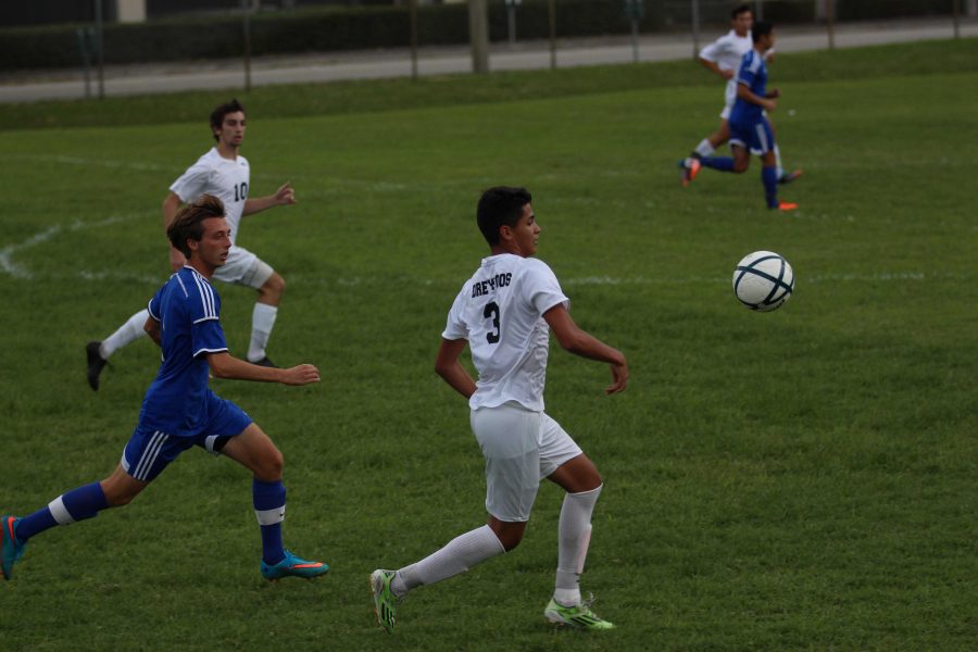 Visual sophomore Carlos Rosales (front) runs to take the ball from a player on the the opposing team while communications sophomore Zachary Stoloff (back) trails behind. 